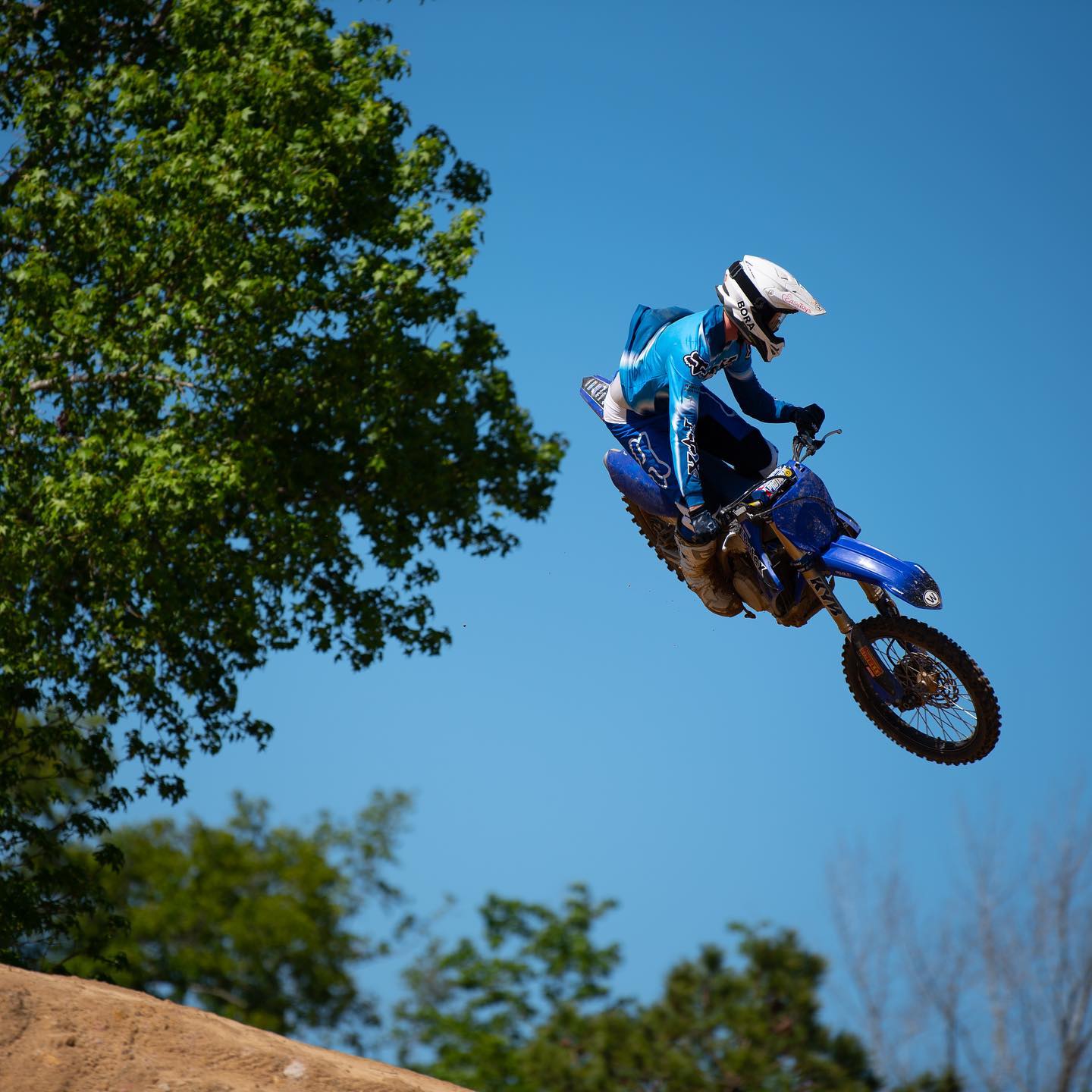 dirt bikes display dirt bike rider flying over tree
